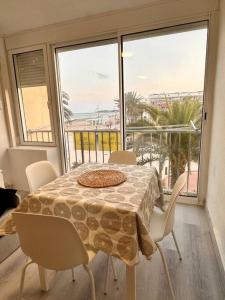 a table and chairs in a room with a large window at A pie de PLAYA in La Pineda