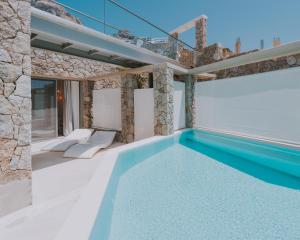 a swimming pool in the middle of a house at Arcs Suites & Residences in Mýkonos City