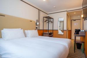 Voodi või voodid majutusasutuse Best Western Plus Au Grand Saint Jean toas