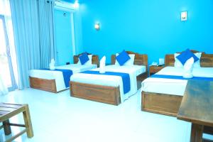 מיטה או מיטות בחדר ב-SP Tourist Hotel Jaffna