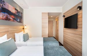 Televisi dan/atau pusat hiburan di Leonardo Boutique Hotel Linz City Center