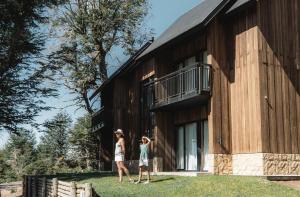 two women are standing outside of a building at El Refugio Ski & Summer Lodge in San Martín de los Andes