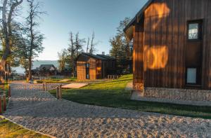 a wooden house with a pathway leading to it at El Refugio Ski & Summer Lodge in San Martín de los Andes