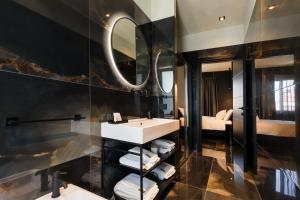 bagno con lavandino e specchio di Etrus - Boutique Room & Rooftop a Pontecagnano