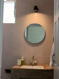 a bathroom with a sink and a mirror at Beseco Bed and Breakfast in Benaulim