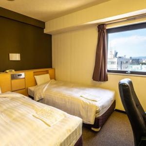 Kama o mga kama sa kuwarto sa Ramada Encore by Wyndham Amagasaki