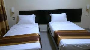 Tempat tidur dalam kamar di Ubuntu Palace Hotel