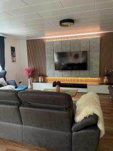 A television and/or entertainment centre at Luxury Apartment near Munich Airport - Therme ED - Parking