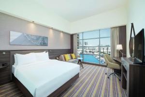 A television and/or entertainment centre at Hampton By Hilton Dubai Airport