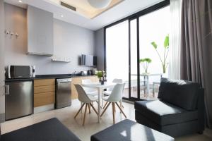 a kitchen and living room with a table and chairs at Kare No Apartments by Sitges Group in Sitges