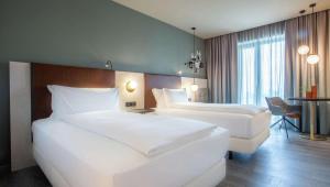 Voodi või voodid majutusasutuse Hilton Garden Inn Mannheim toas