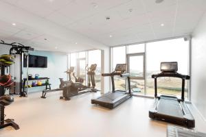 un gimnasio con equipo cardiovascular y una gran ventana en Hilton Garden Inn Faroe Islands, en Tórshavn