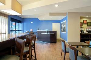 a restaurant with blue walls and tables and chairs at Hampton Inn Merrillville in Merrillville