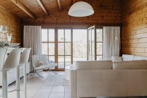 a living room with a white couch and a table at Life & Cooking Holiday Home in Ermelo