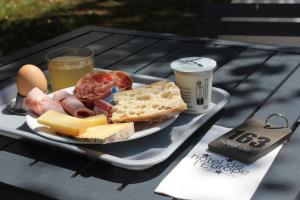 a tray with a plate of food on a table at Logis Hôtel de l'Europe in Poitiers