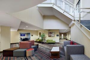 a lobby of a hospital with chairs and stairs at Hampton Inn & Suites Mt. Prospect in Mount Prospect