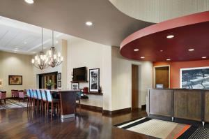 a lobby with a bar and a dining room at Hampton Inn & Suites Mt. Prospect in Mount Prospect