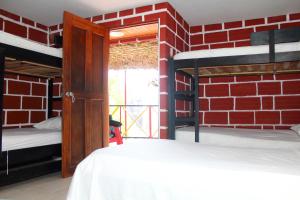 A bed or beds in a room at Hostal La Guaca