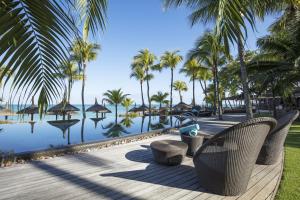 a resort with palm trees and a swimming pool at Royal Palm Beachcomber Luxury in Grand Baie