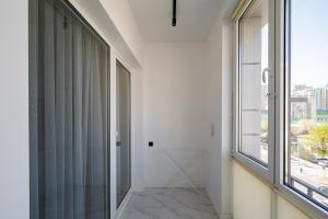 a hallway with a glass door and a window at Апартаменты бизнес-класса в ЖК 4YOU in Almaty