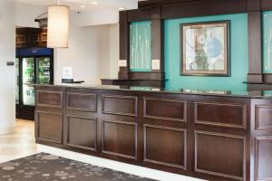 a large wooden bar in a hotel lobby at Hilton Garden Inn Cincinnati/Mason in Mason