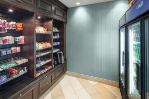 a grocery store aisle with a refrigerator with food at Hilton Garden Inn Cincinnati/Mason in Mason