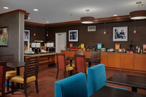 a restaurant with tables and chairs and a counter at Hampton Inn Alamogordo in Alamogordo