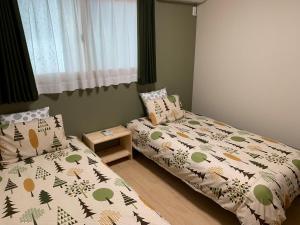 Cama ou camas em um quarto em Guesthouse Kaede Annex