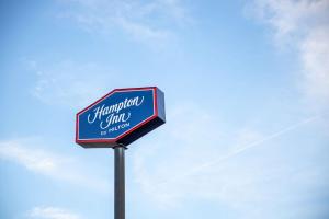 una señal para una posada hampton en un poste en Hampton Inn by Hilton of Kuttawa Eddyville, en Kuttawa