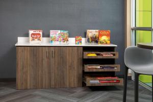 a counter with food and books on it in a room at Tru By Hilton Miami West Brickell in Miami