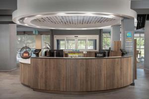 a lobby with a reception desk in a building at Tru By Hilton Miami West Brickell in Miami