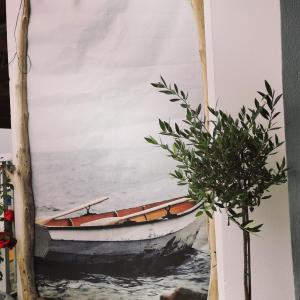 a painting of a boat in the water at Elli's House in Keramotí