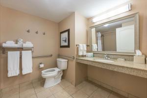 a bathroom with a toilet and a sink and a mirror at Hampton Inn & Suites by Hilton Moncton in Moncton