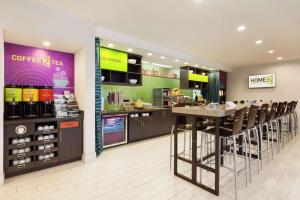 a coffee shop with bar stools in a store at Home2 Suites by Hilton Amarillo West Medical Center in Amarillo