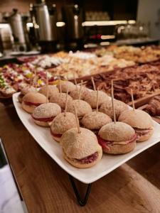 a white tray filled with sandwiches on a table at All Seasons Residence in Zlatibor