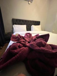 a red blanket laying on top of a bed at Sandra Hotel in Amman