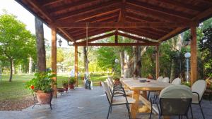 a wooden pavilion with a wooden table and chairs at Villa Vivere in Corfu Town