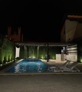 a swimming pool at night with a pavilion at Spa Lux Apatin in Apatin