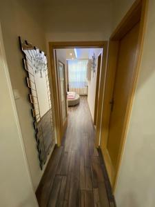 a hallway leading to a room with a toilet in it at Robert's Apartment in Celje