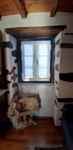 a room with two windows in a house at Casa do Loureiro in Arganil