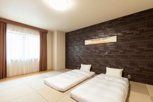 Cama ou camas em um quarto em Tabino Hotel lit Matsumoto Milky white Onsen