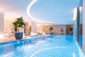 a swimming pool in a hotel with a circular ceiling at The Peninsula Paris in Paris