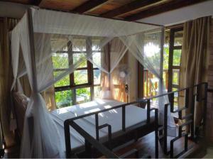 A bed or beds in a room at Moemoea Lodge