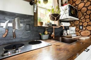 a kitchen with a sink and a wooden counter top at Cozy AF Tiny-House Oasis in Tampa