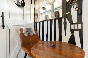 a wooden chair with a table in a room at Cozy AF Tiny-House Oasis in Tampa