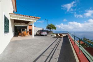 a house with a balcony with a view of the ocean at Casa Vista Mar by GALMI in Calheta