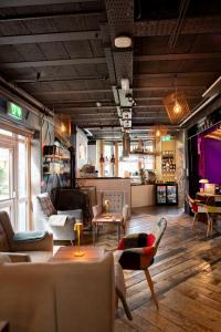 a living room with couches and chairs and a table at The Nest Boutique Hostel in Galway