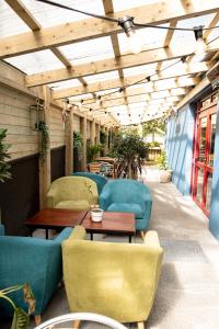 a patio with couches and a table and chairs at The Nest Boutique Hostel in Galway