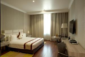 una camera d'albergo con letto, scrivania di City Tower Hotel a Kuwait