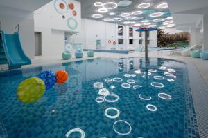 a pool with balls on the water in a building at Mirotel Resort and Spa in Truskavets